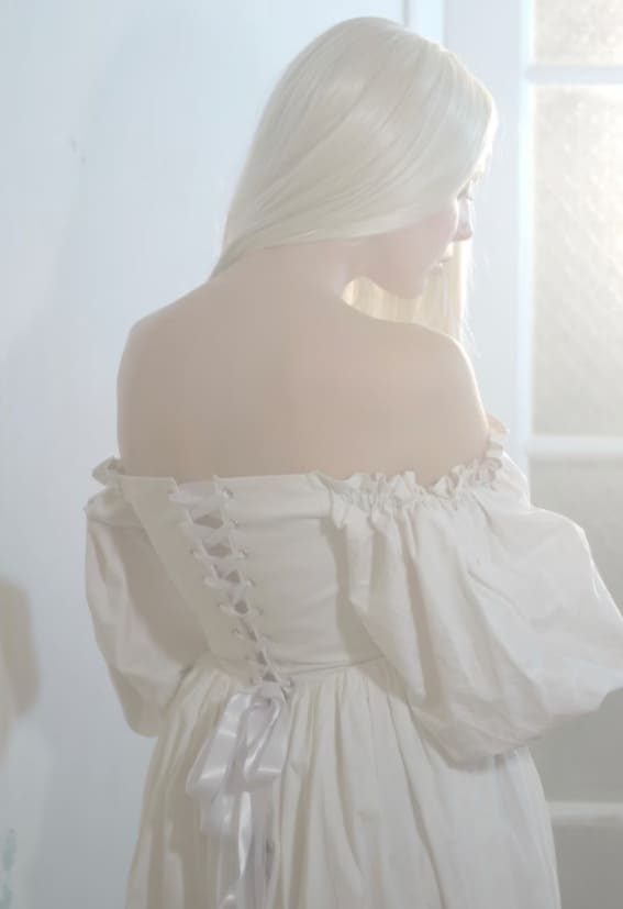 bride to be standing in white corset dress